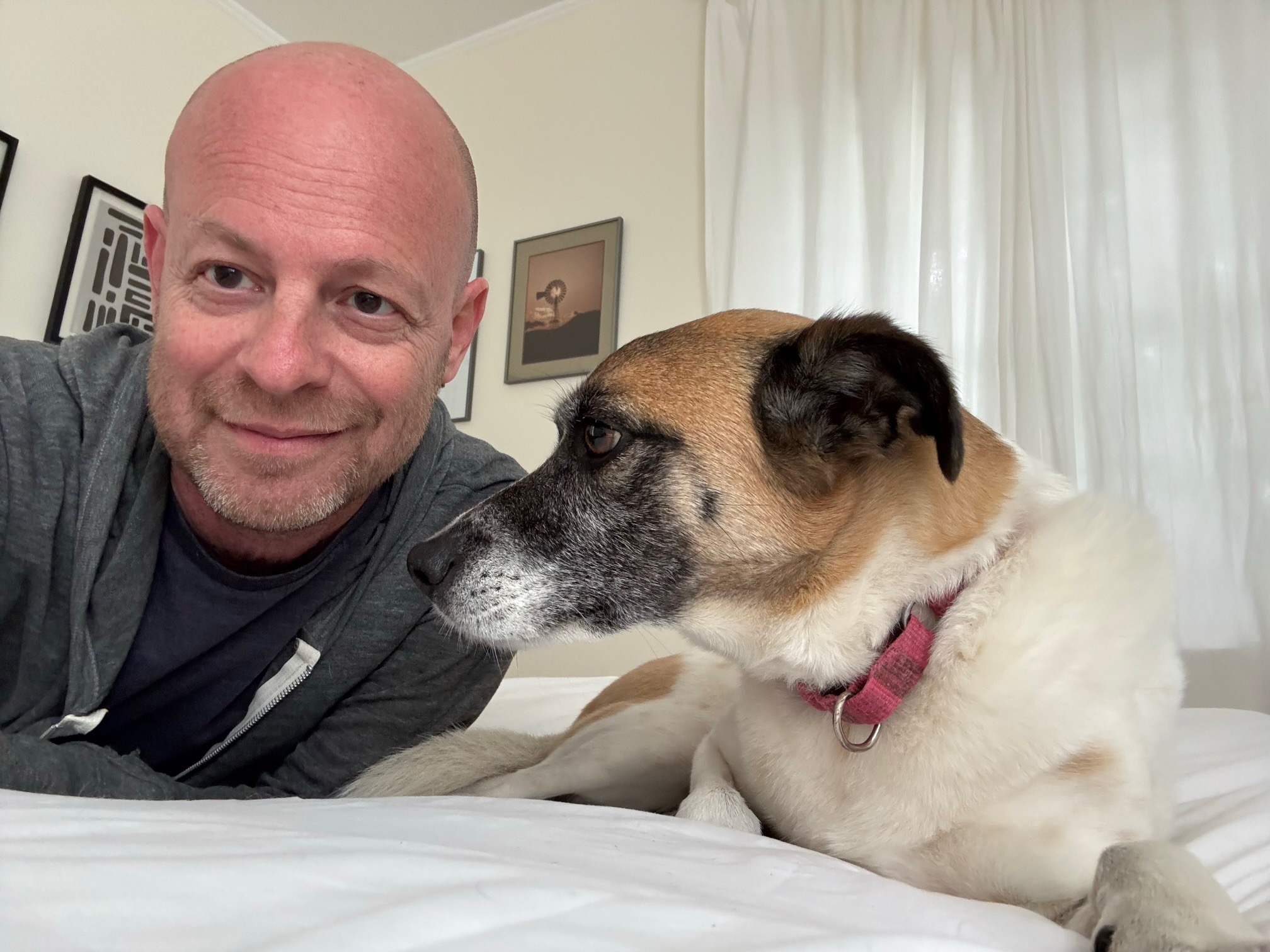 Marc relaxing with a dog during an in-home stay
